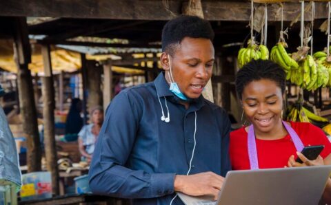 young-african-business-man-feels-excited-as-he-shows-market-woman-some-information-his-laptop_216356-1234